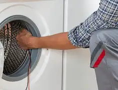 Dryer repair technician diagnosing and servicing a clothes dryer in Overland Park, KS