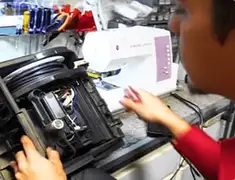 Vacuum repair technician servicing internal components on a workbench in Overland Park, KS